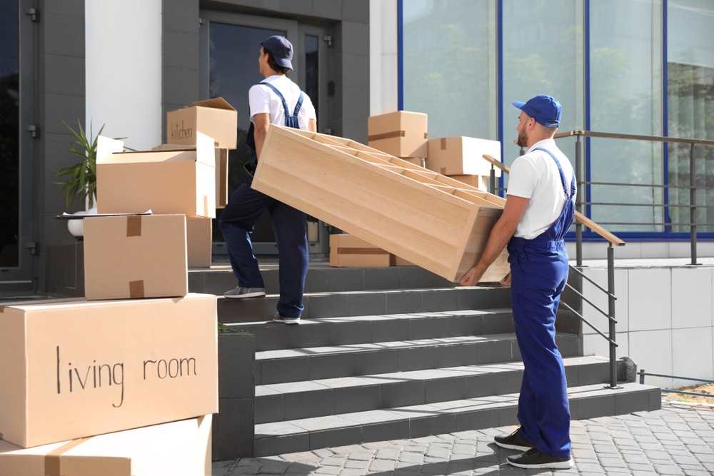 Removalist carrying furniture on a moving day