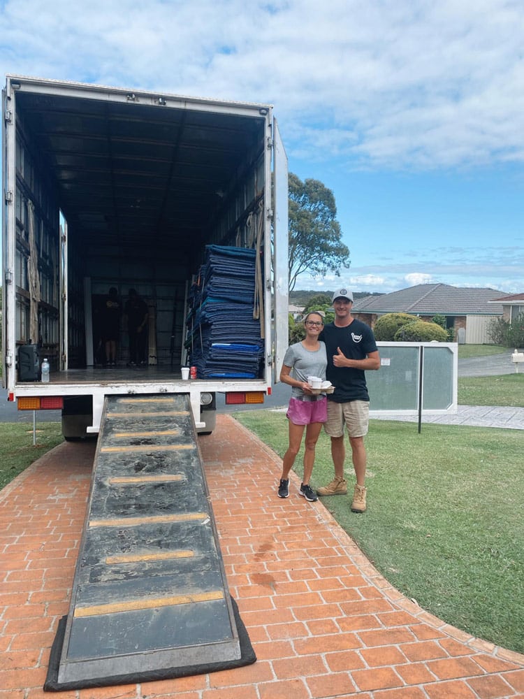 Couple Standing Beside a Vehicle Used for Interstate Moving