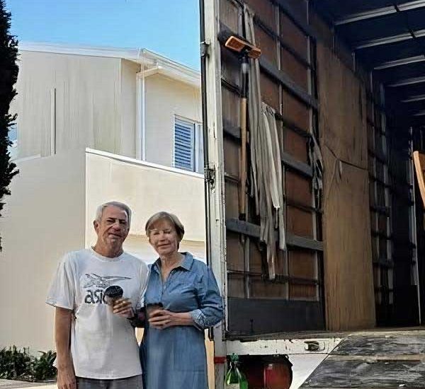 Couple Standing Beside The Open Truck — Easy Choice Removals & General Freight in Port Macquarie, NSW