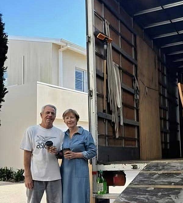 Couple Standing Beside The Open Truck — Easy Choice Removals & General Freight in Port Macquarie, NSW