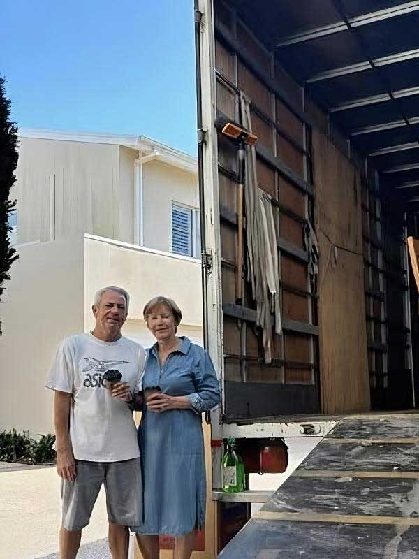 Couple Standing Beside The Open Truck — Easy Choice Removals & General Freight in Port Macquarie, NSW