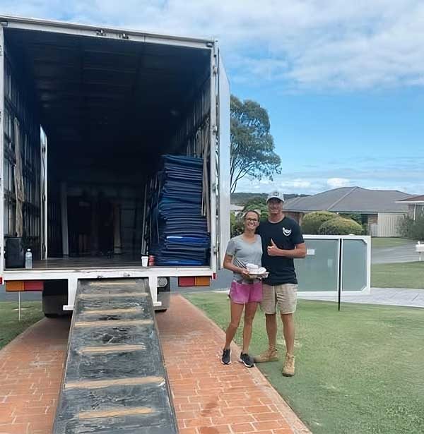 Couple Standing Beside The Open Truck — Easy Choice Removals & General Freight in Raymond Terrace, NSW Couple Standing Beside The Open Truck — Easy Choice Removals & General Freight in Raymond Terrace, NSW