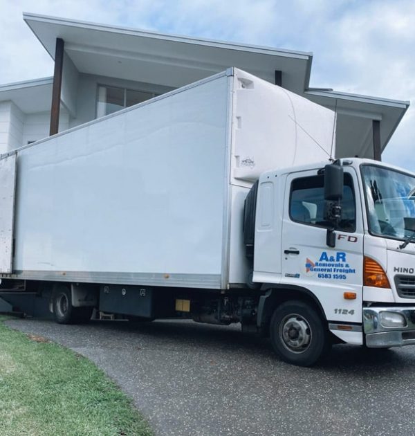 Moving Truck Parked In Front Of A House