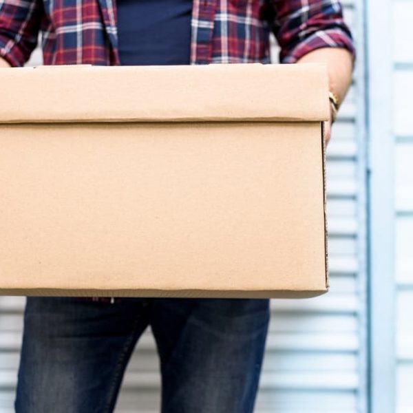 Young Man Holding Box — Removals & General Freight in Port Macquarie, NSW